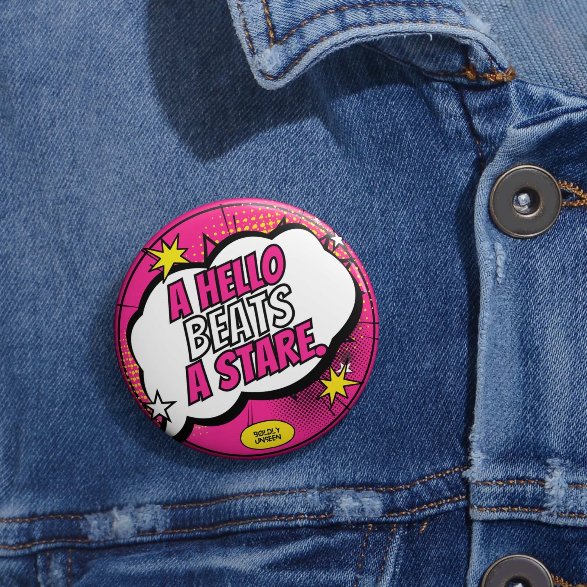 A Hello Beats a Stare. hot pink pin badge worn on a blue denim jacket