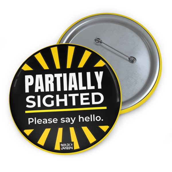 Partially Sighted. Please Say Hello. pin badge, black face with yellow sunburst edging and white lettering, shown with its metal pin-back