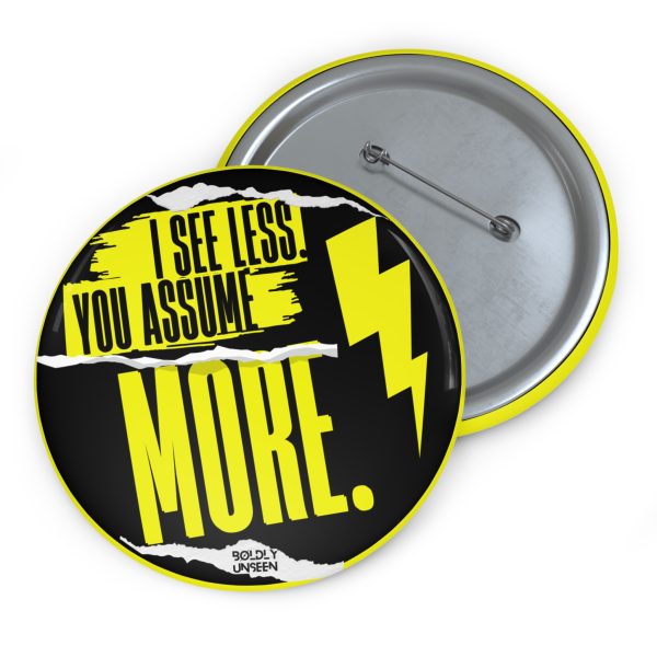 Front and metal pin-back of the I See Less. You Assume More. pin badge